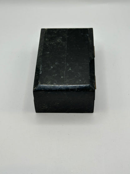 Rear of the black tessellated box showing two brass hinges
