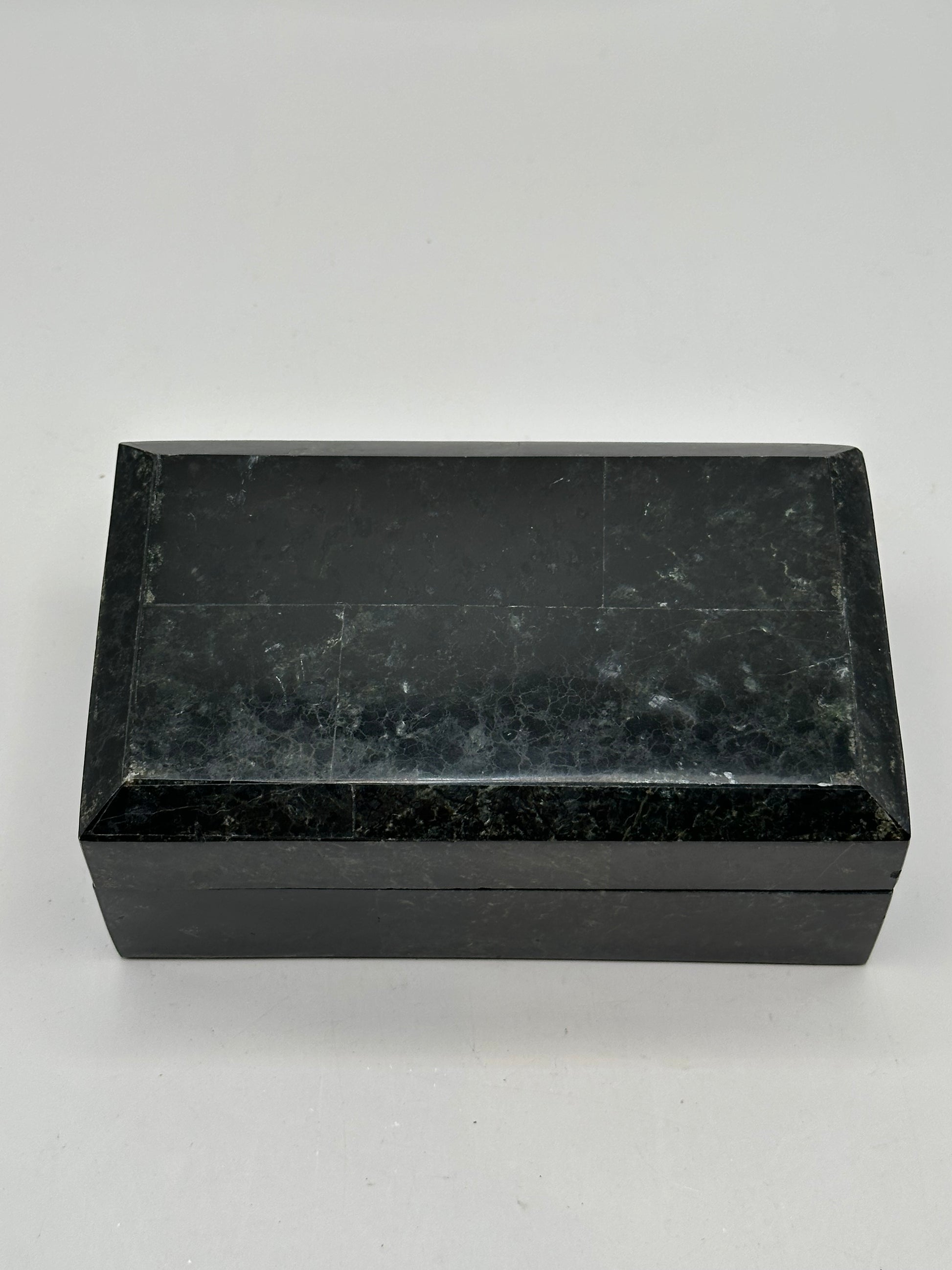 Open box lid showing the gold Renoir maker's label on black velvet