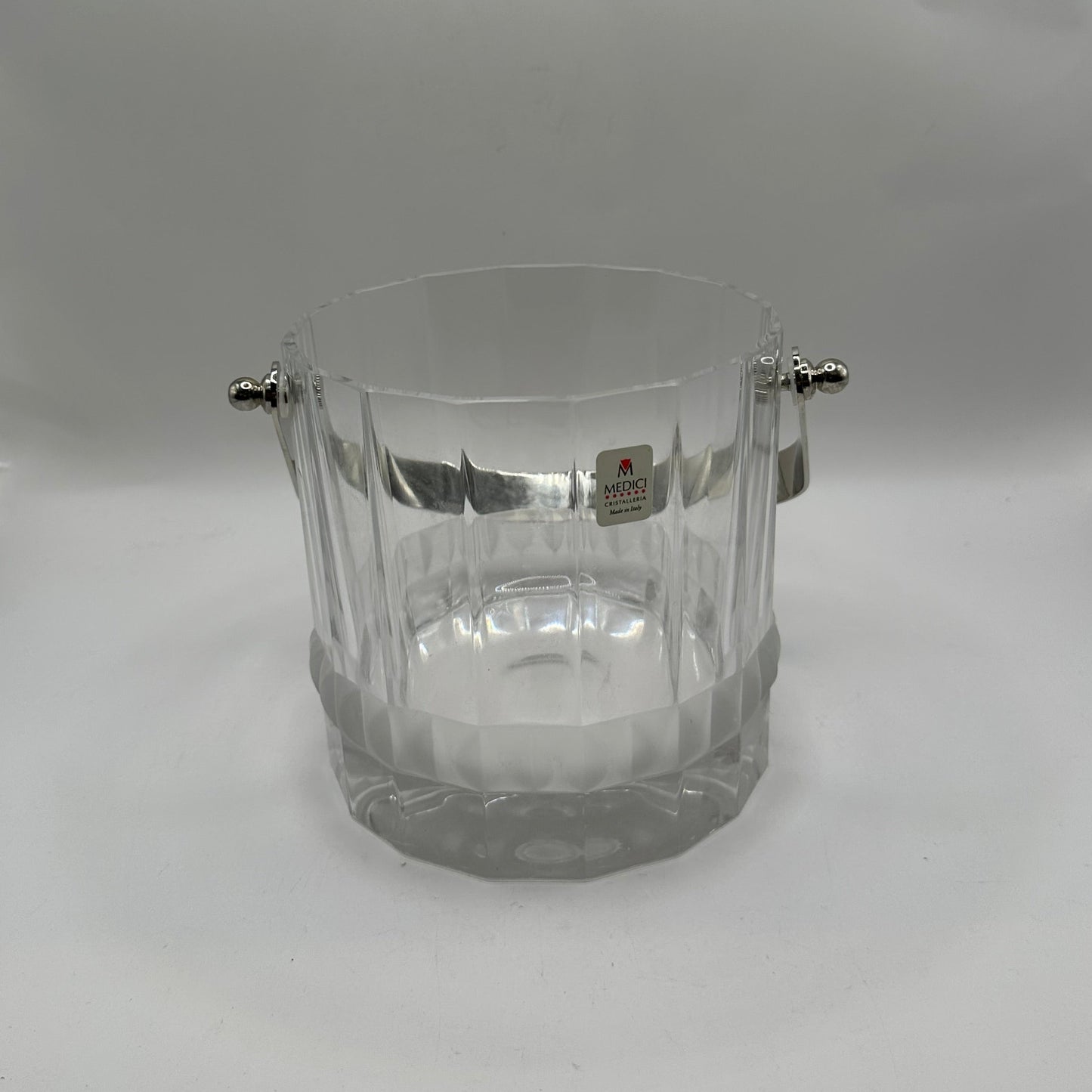 MCM crystal ice bucket, front view with handle raised and Medici Crystal Made in Italy label