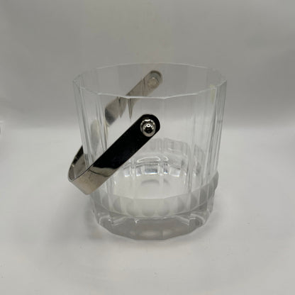 Close-up of the crystal ice bucket's silver swing handle against the faceted body