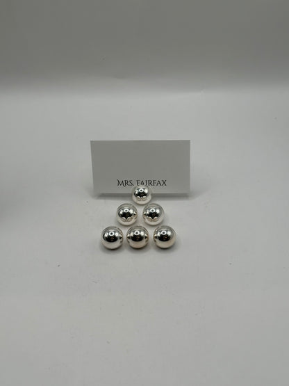 MCM stainless steel spherical place card holders, six polished spheres clustered with a place card