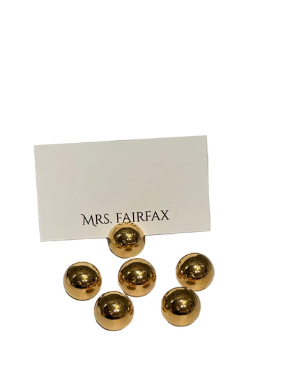 MCM brass spherical place card holders, six polished brass spheres with one holding a place card