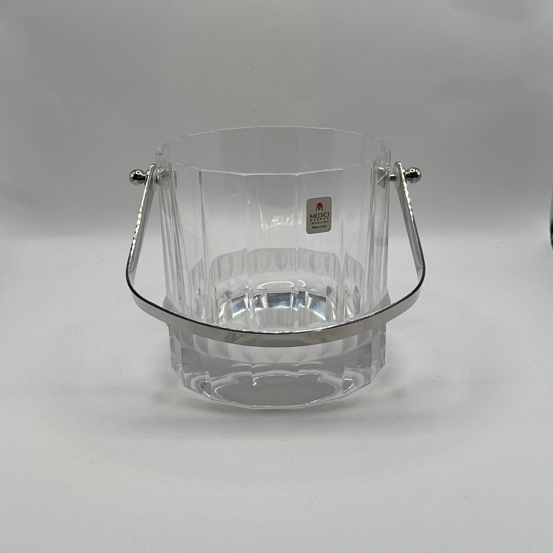 MCM crystal ice bucket, front view with handle lowered and gold Medici Crystal label