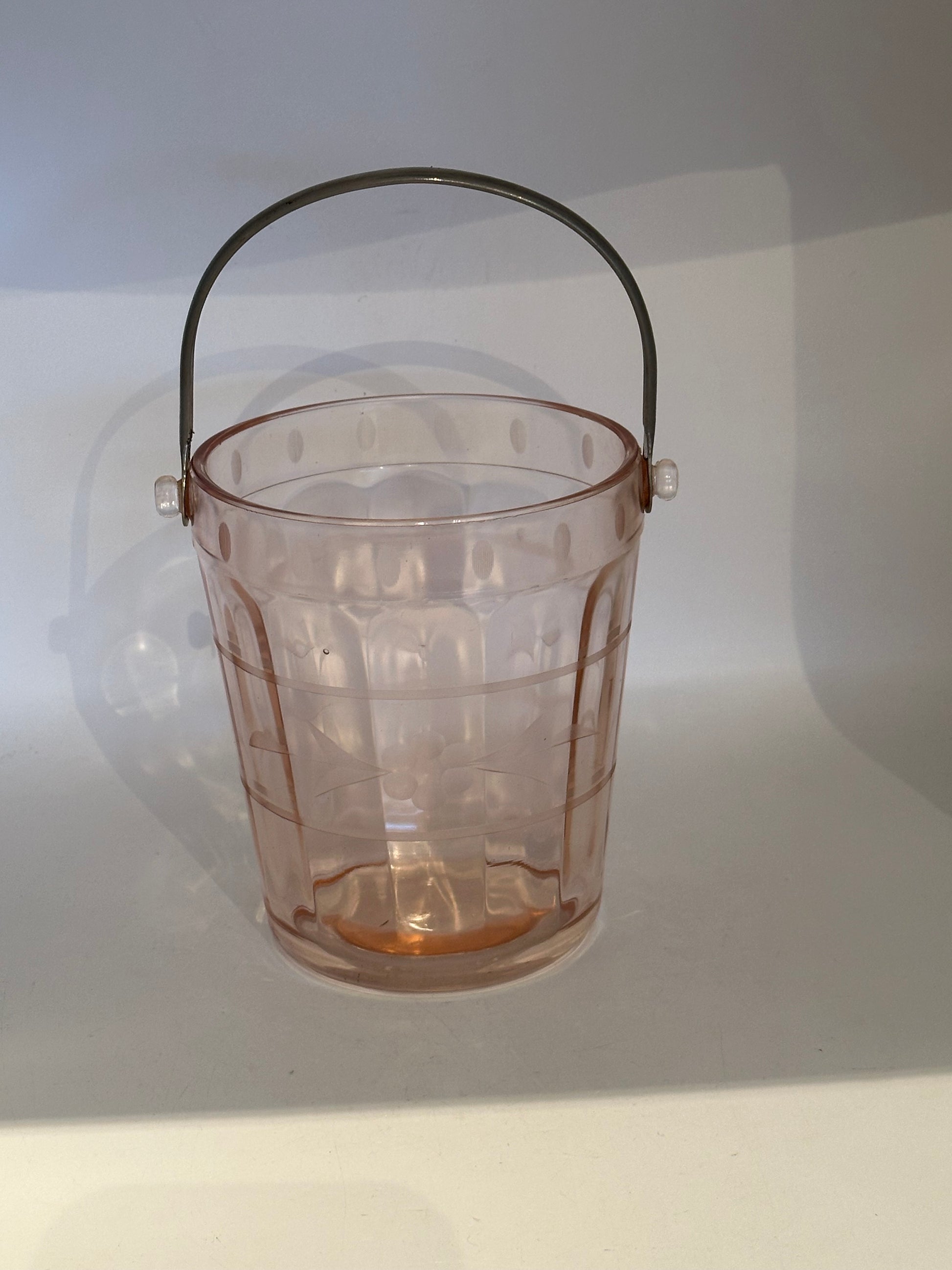 Pink depression glass ice bucket with paneled sides and metal swing handle