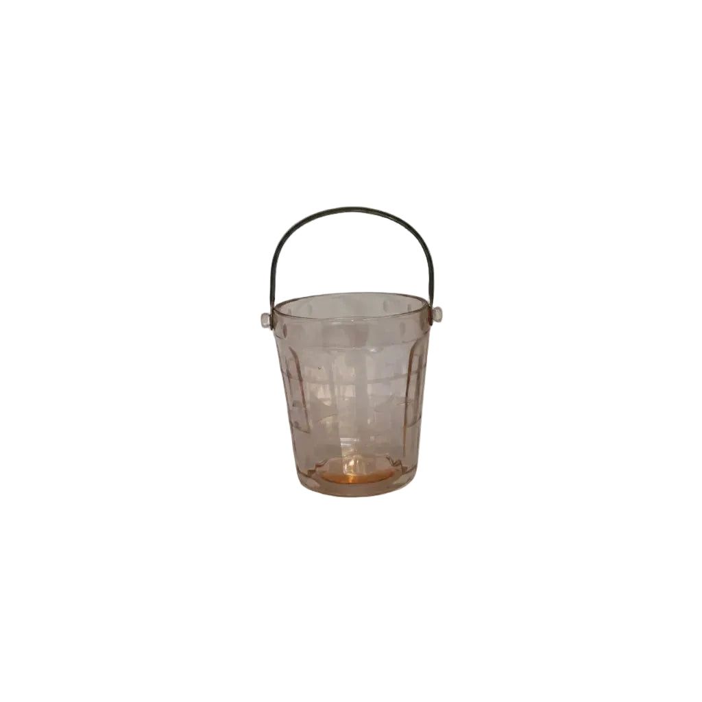 Pink depression glass ice bucket with arched metal swing handle, front view