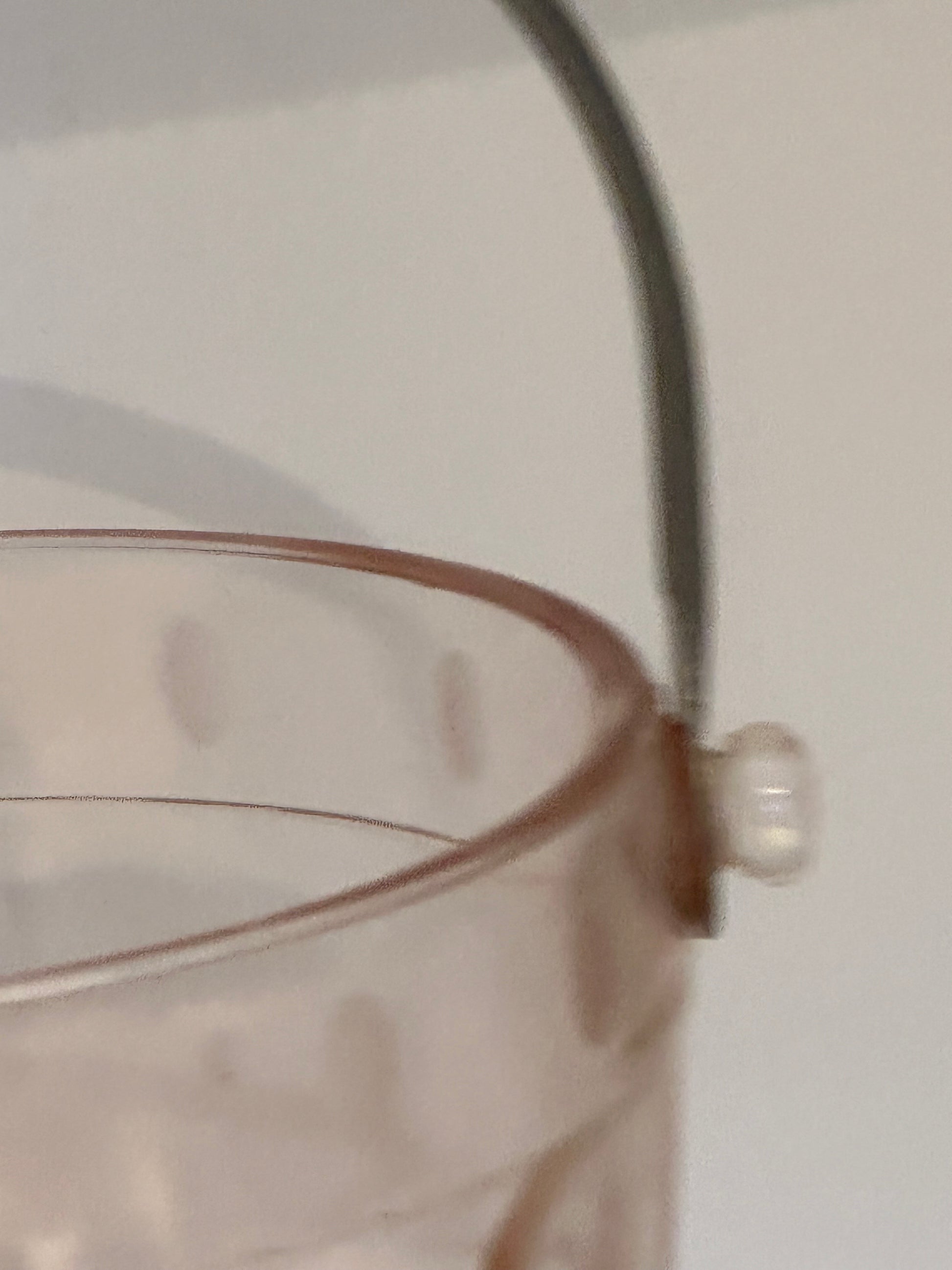 Close-up of the metal handle attachment and glass knob on the pink ice bucket