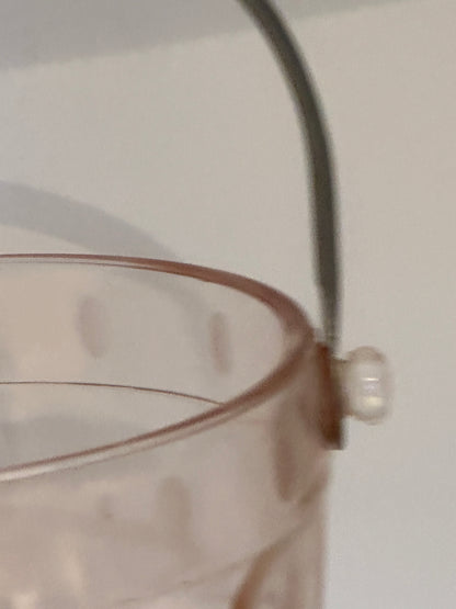 Close-up of the metal handle attachment and glass knob on the pink ice bucket