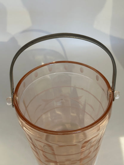 Top view into the pink glass ice bucket showing etched bands and metal handle
