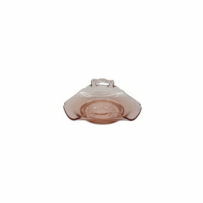 Pink depression glass handled dish, low side view on white