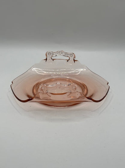 Pink depression glass dish with center floral etch, angled side view