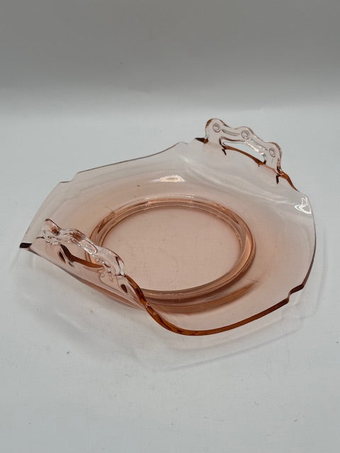 Pink glass handled dish viewed from above at an angle