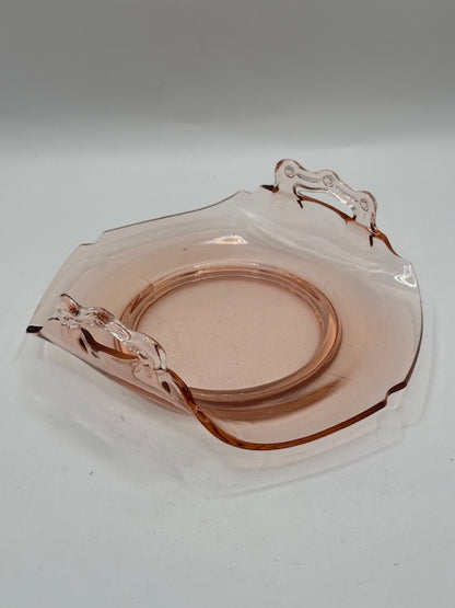 Pink glass handled dish viewed from above at an angle