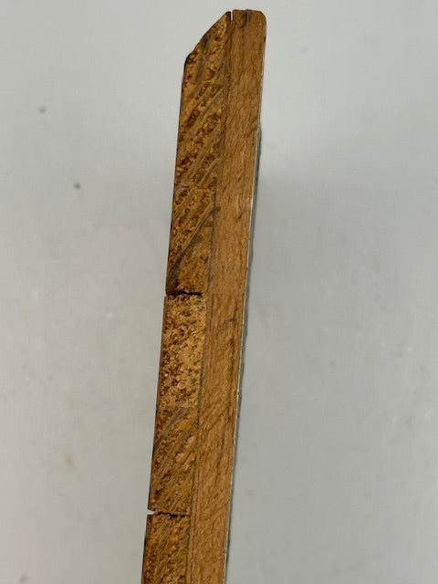 Edge view of the Firle painting's wood panel showing thickness and a horizontal crack