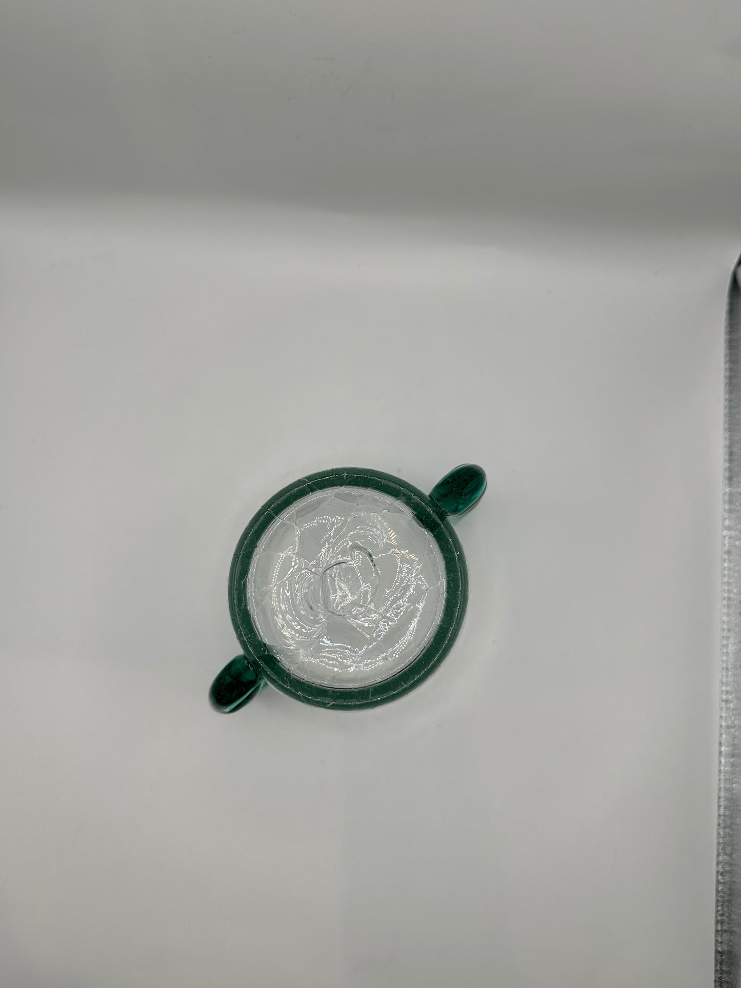 Detail of the MCM Blenko vase rim and applied teal glass handle from above
