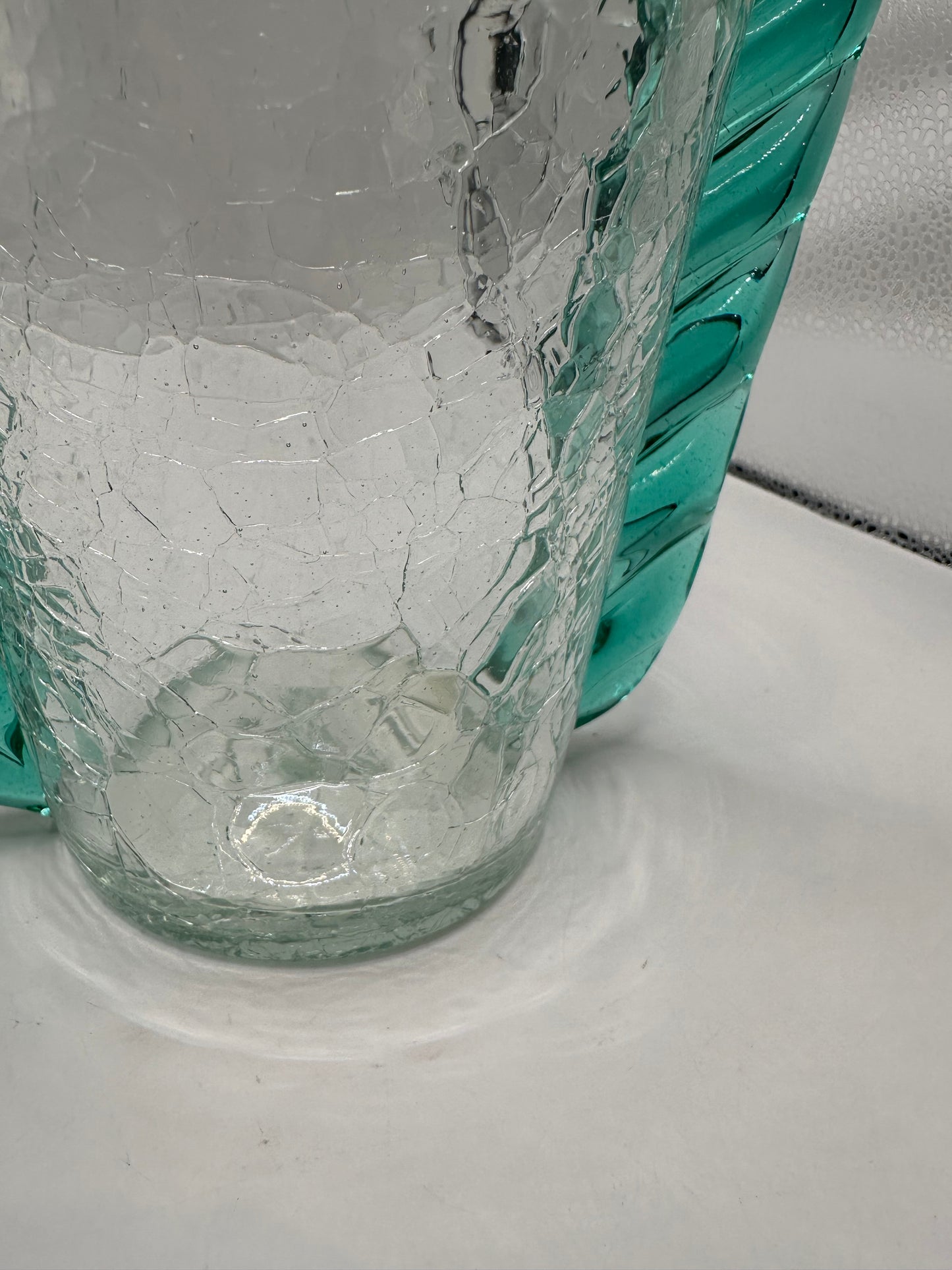 Close-up of the MCM Blenko crackle vase base showing crackled glass texture and teal trim