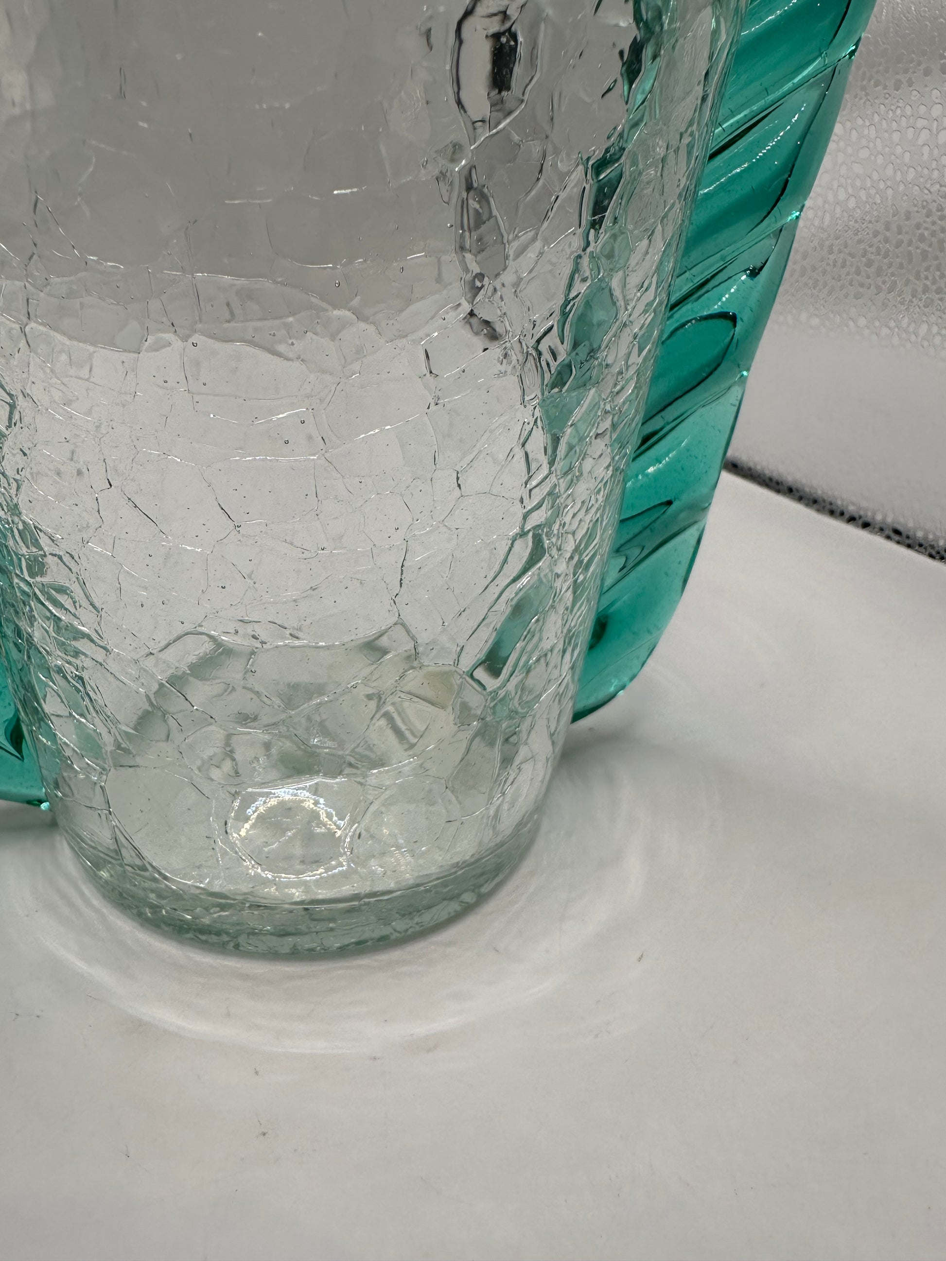 Close-up of the MCM Blenko crackle vase base showing crackled glass texture and teal trim