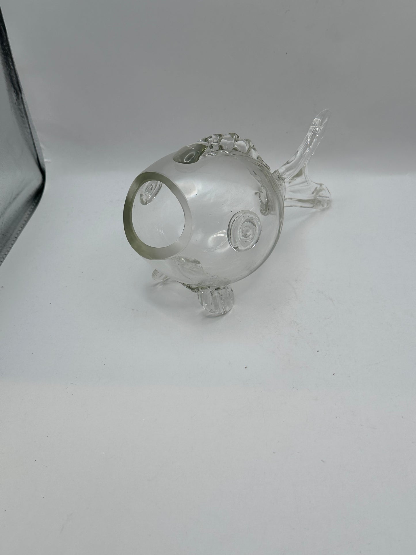 Angled view of the Blenko glass fish vase showing raised eye, mouth opening and tail
