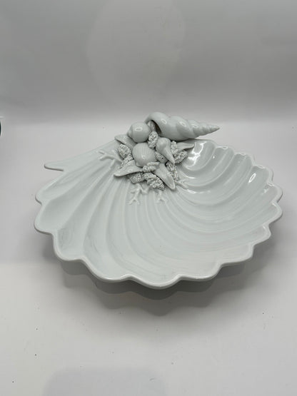 White porcelain scallop shell dish with molded seashells and conch, three-quarter view