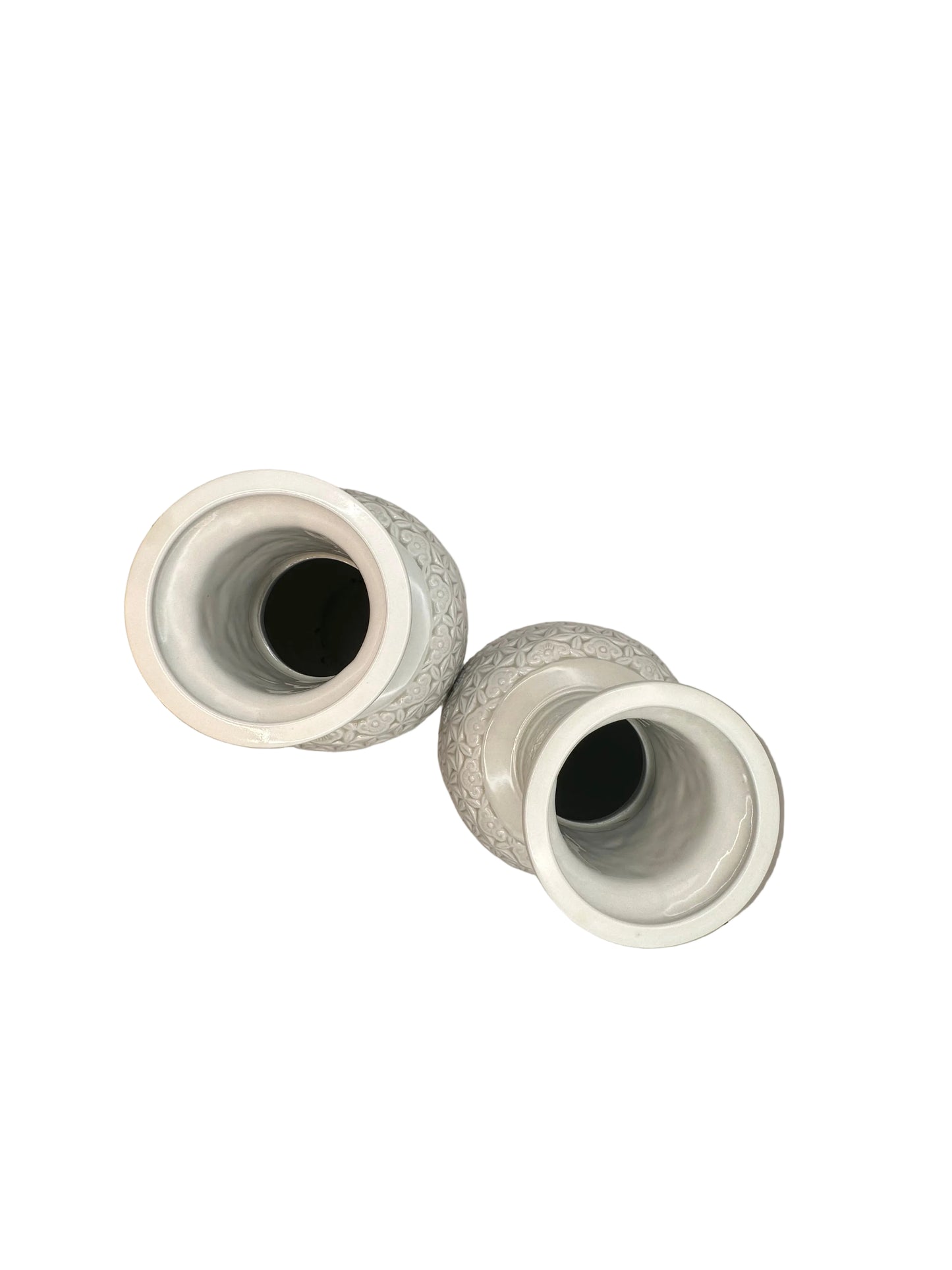 Top view of the two white porcelain vases on their sides showing the open mouths