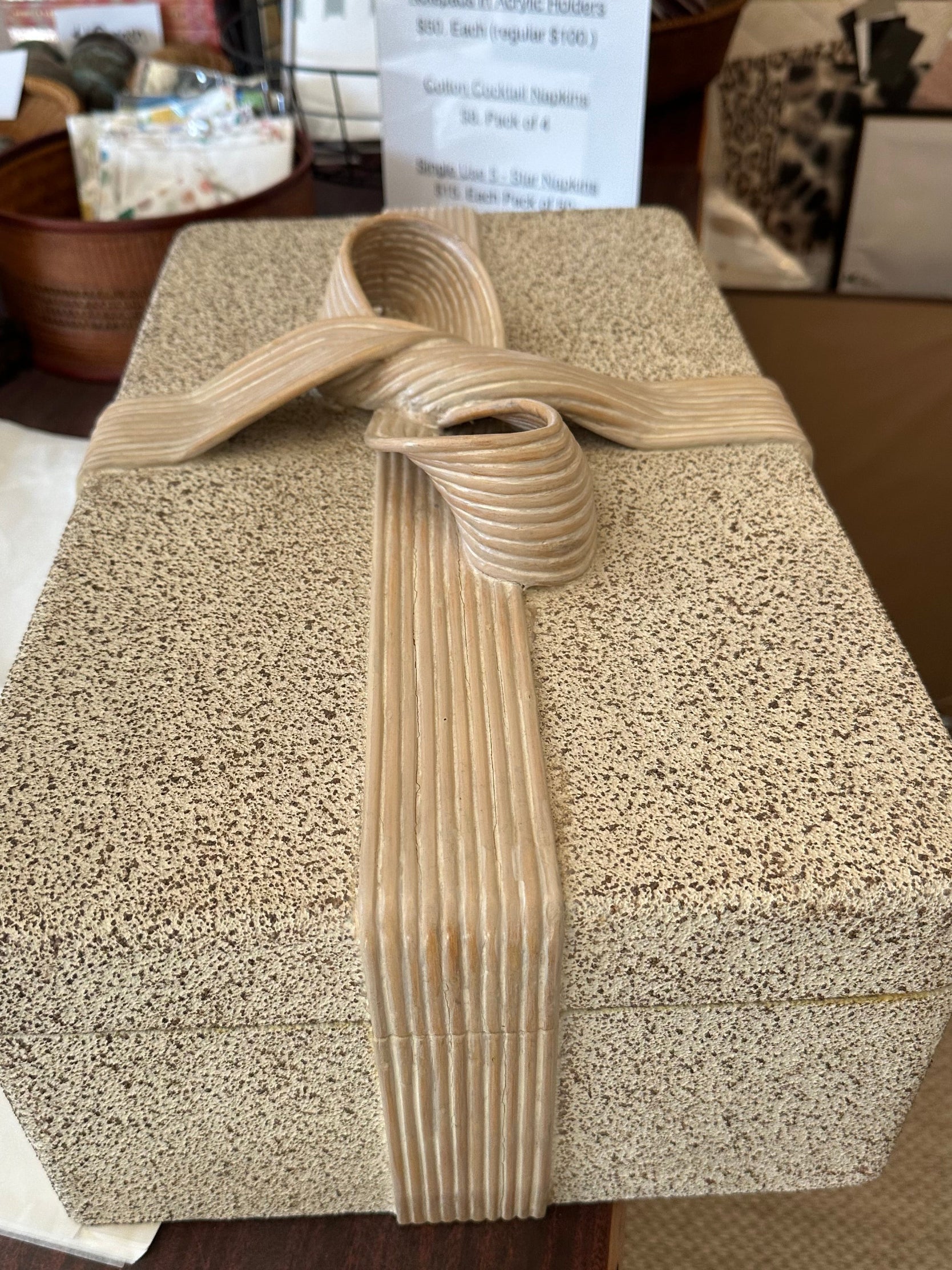 Top view of the closed pencil-reed box showing the full carved bow on the lid