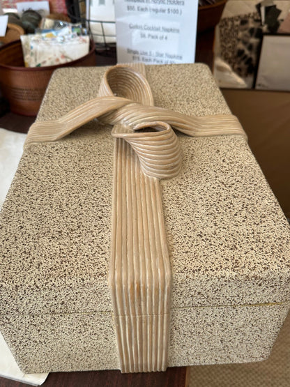 Top view of the closed pencil-reed box showing the full carved bow on the lid