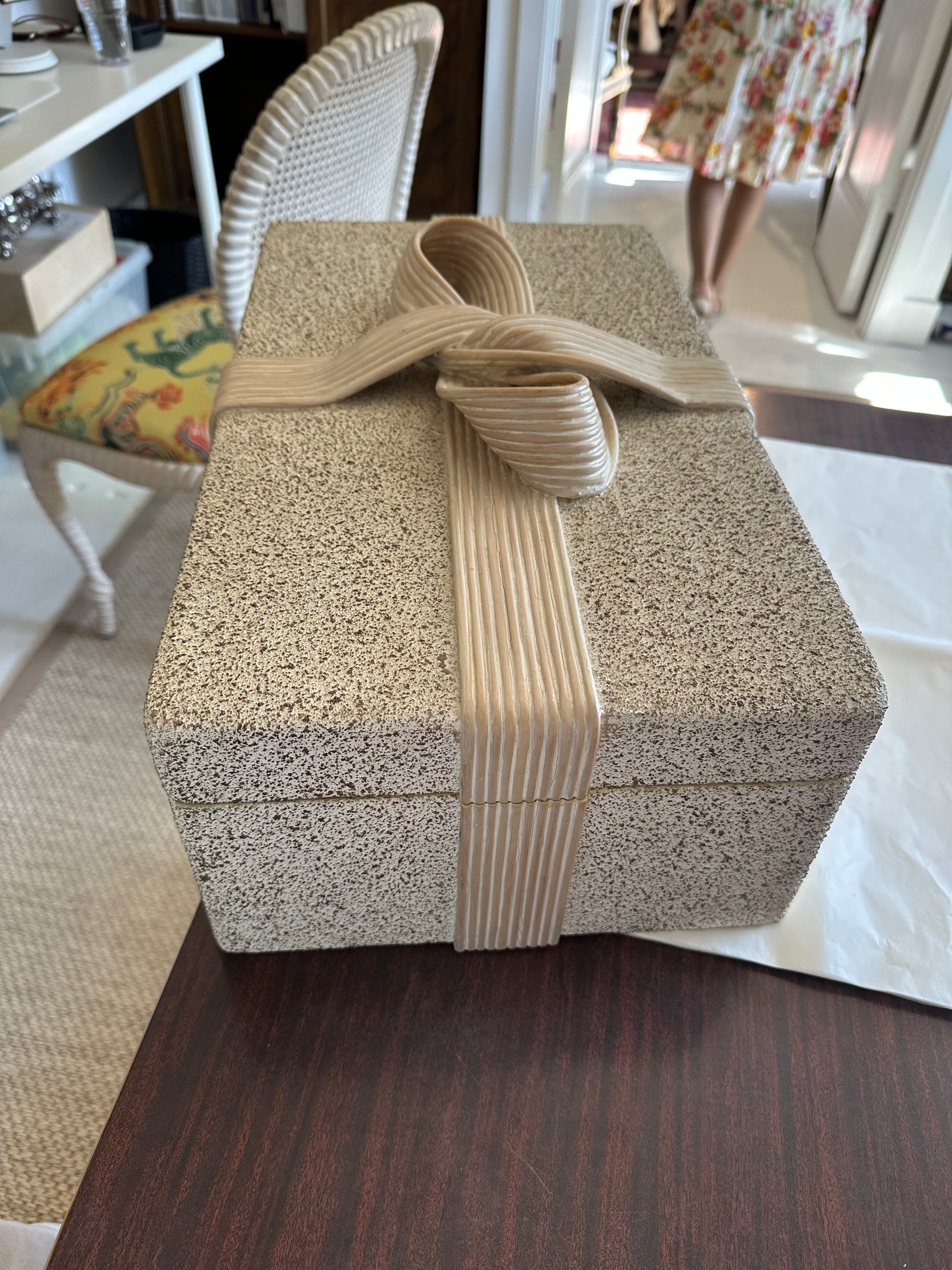 Pencil-reed hinged box with speckled finish and reed bow, angled side view