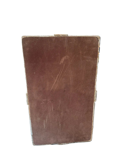 Underside of the pencil-reed box showing the dark brown base panel