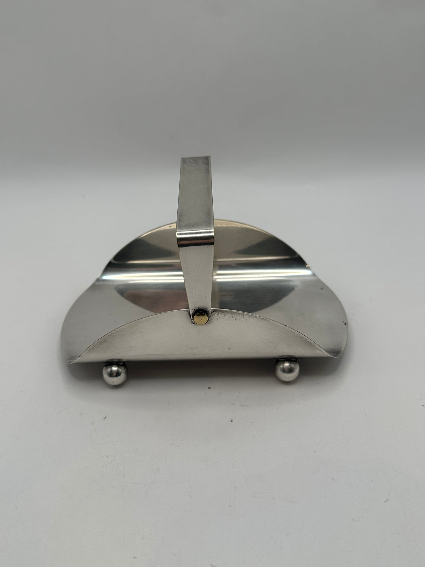 Front view of the Deco silver-plate basket with arched handle and ball feet