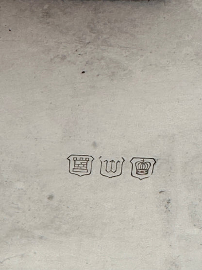 Close-up of the basket's hallmarks: a tower, the letter 'W', and a crown in shields