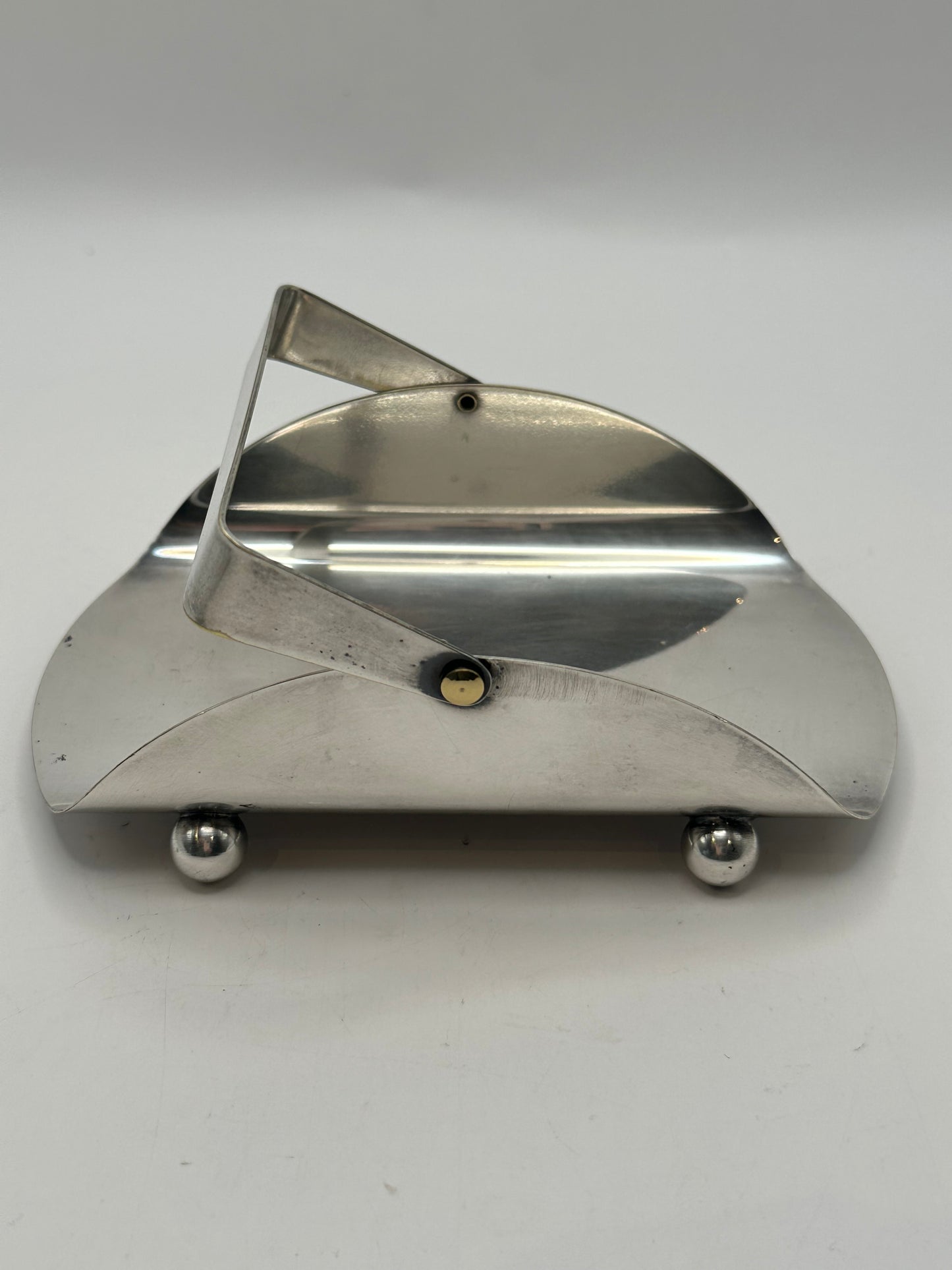 Side view of the silver-plate basket with its handle folded down