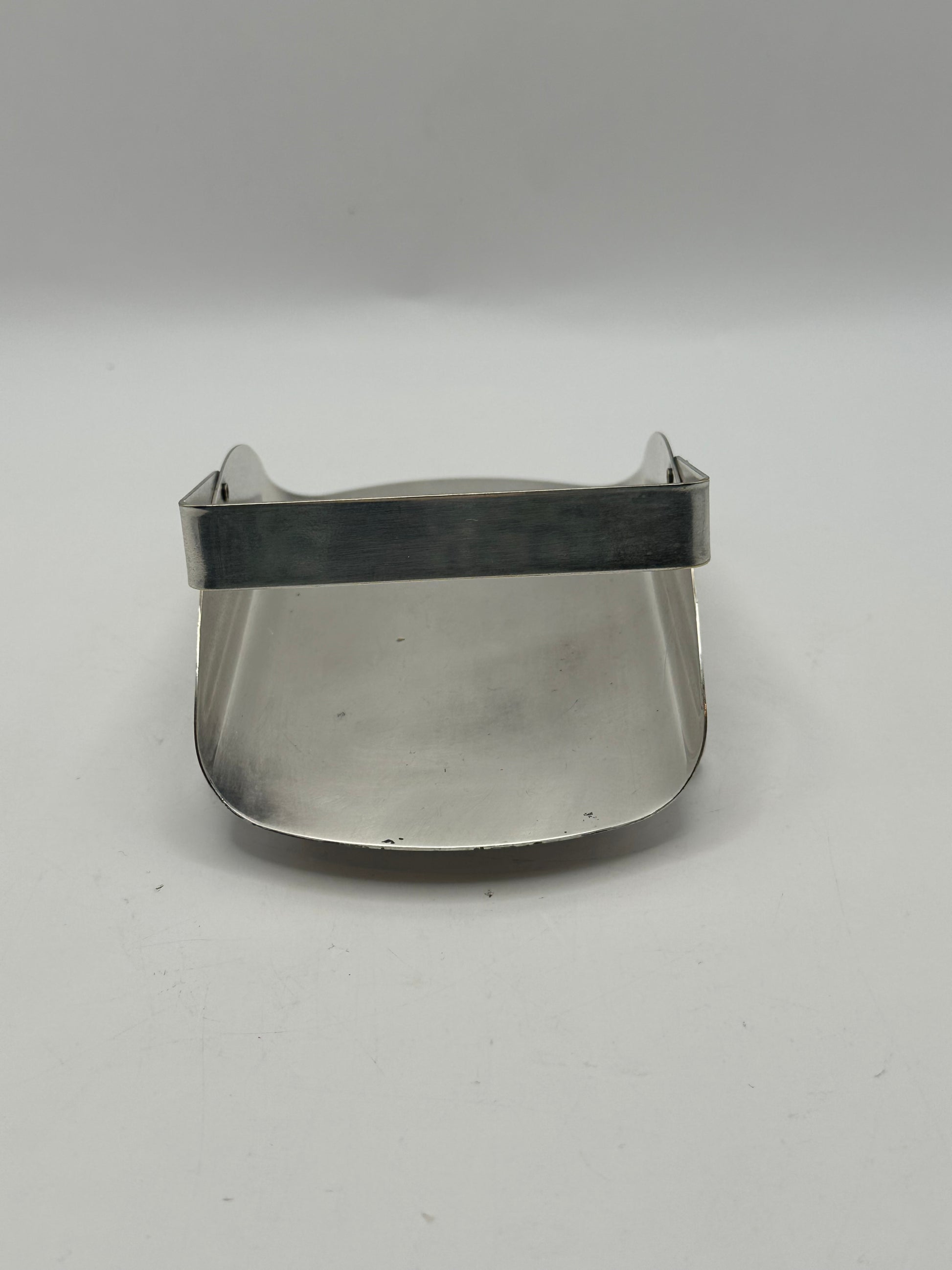Side view of the silver-plate basket showing its sloping curved sides