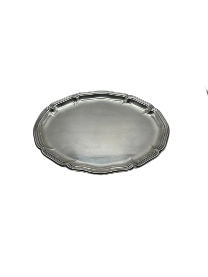 Oval silver-plate tray with a scalloped piecrust rim, top-angled view