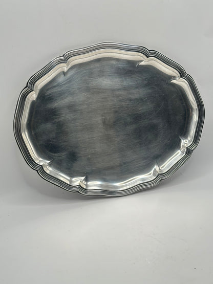 Top-down view of the oval silver-plate tray with its scalloped molded rim