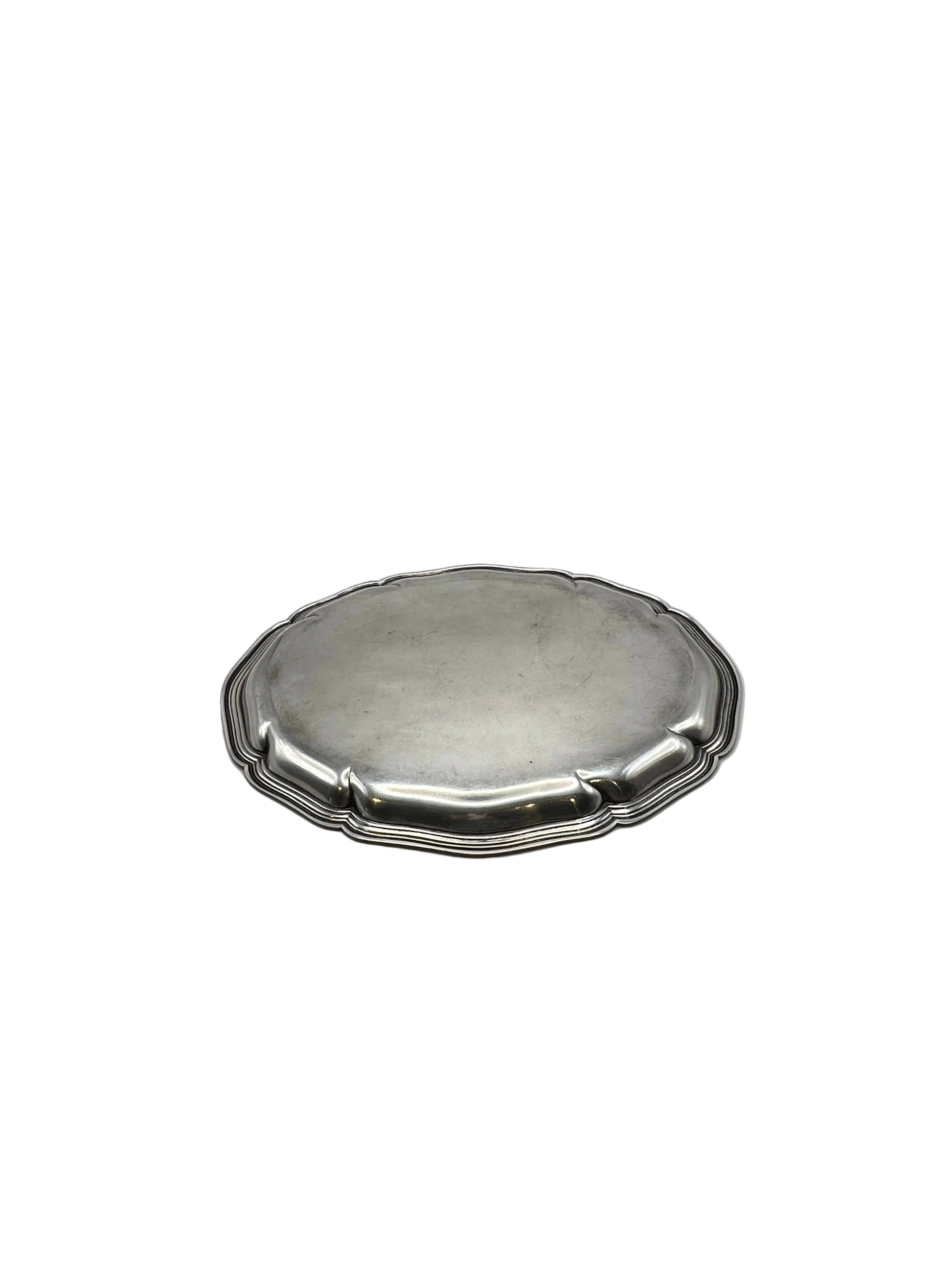 Low-angle view of the oval scalloped silver-plate tray