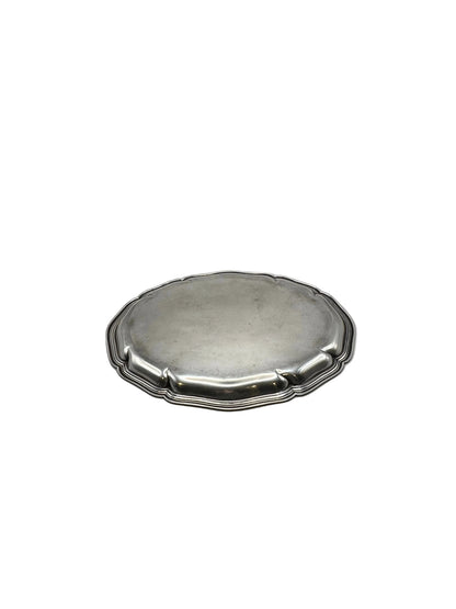 Low-angle view of the oval scalloped silver-plate tray