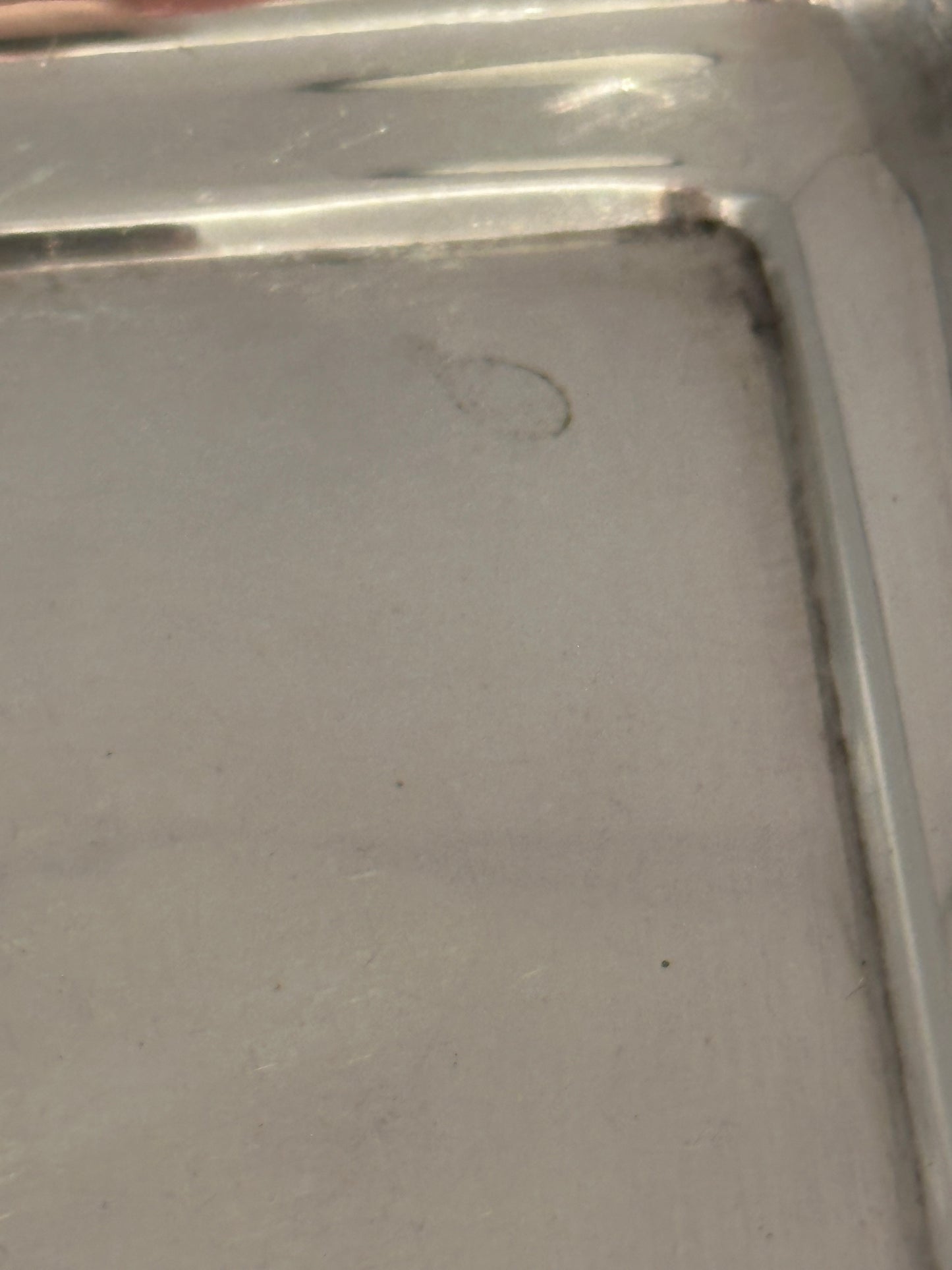 Close-up of the tray's inner corner showing the recessed well and edge