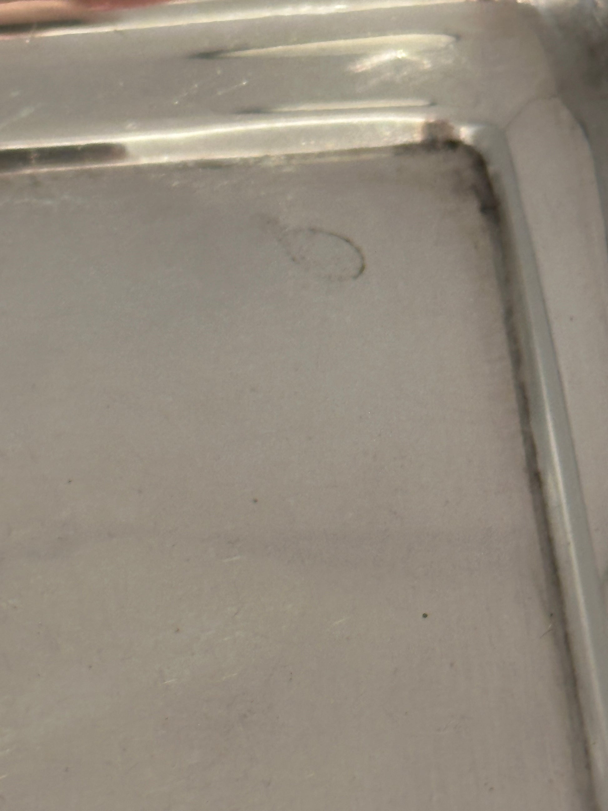 Close-up of the tray's inner corner showing the recessed well and edge