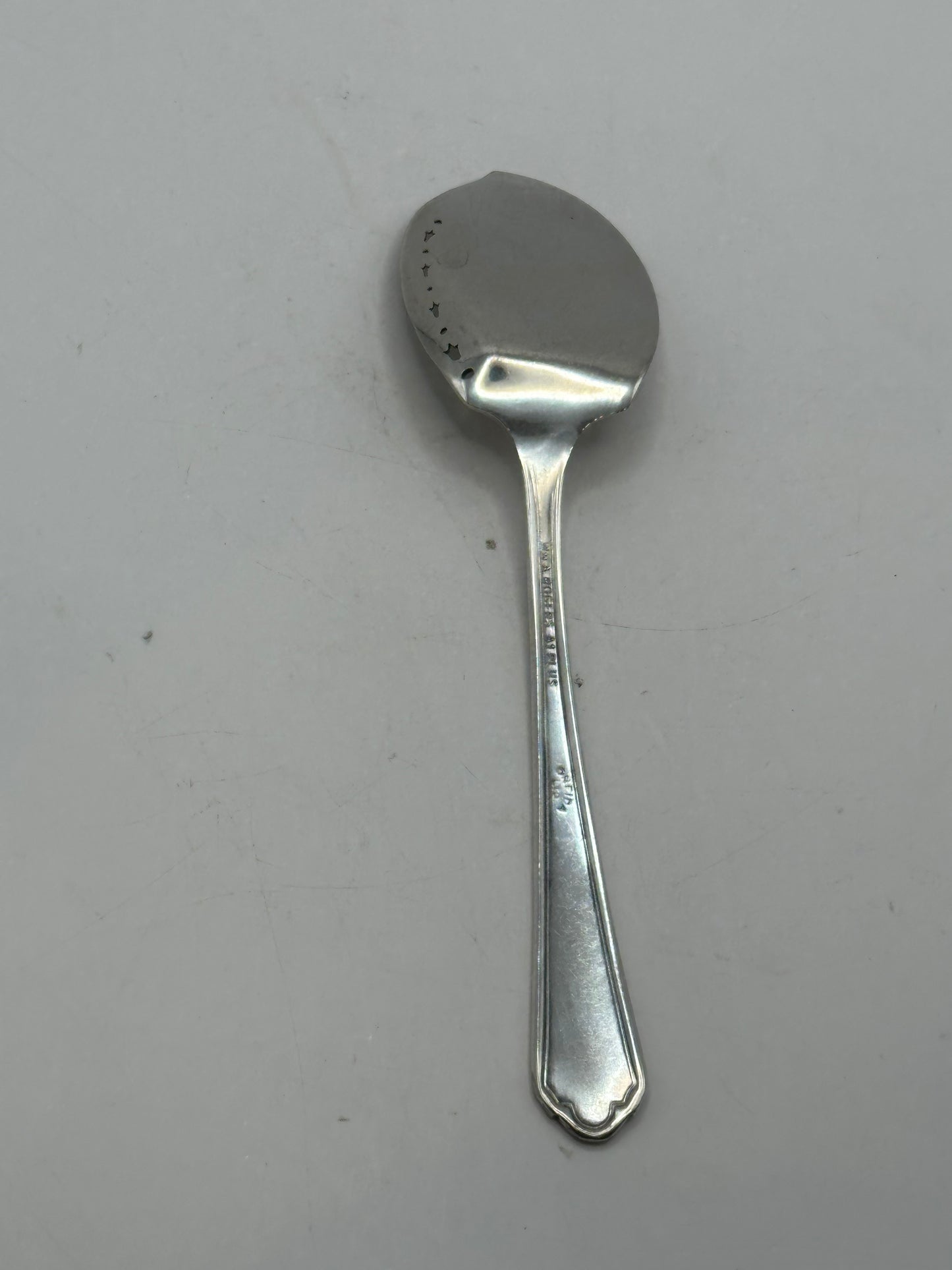 Back of the aspic spoon showing the maker's mark on the handle