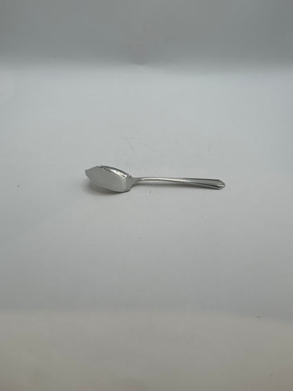 Side profile of the silver-plate aspic spoon showing its angled flat bowl