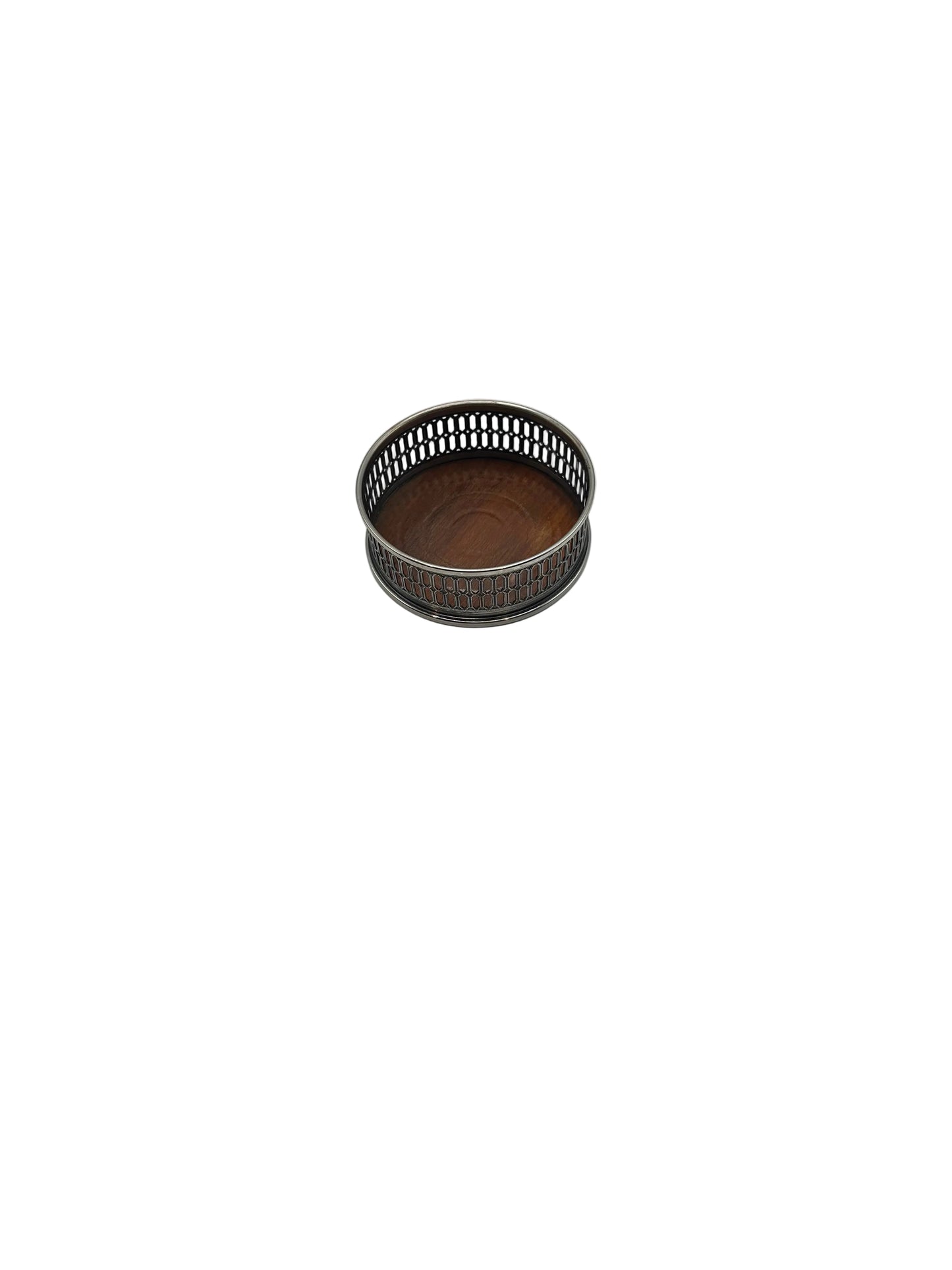 Wine bottle coaster from above at an angle, with pierced silver rim and wood base