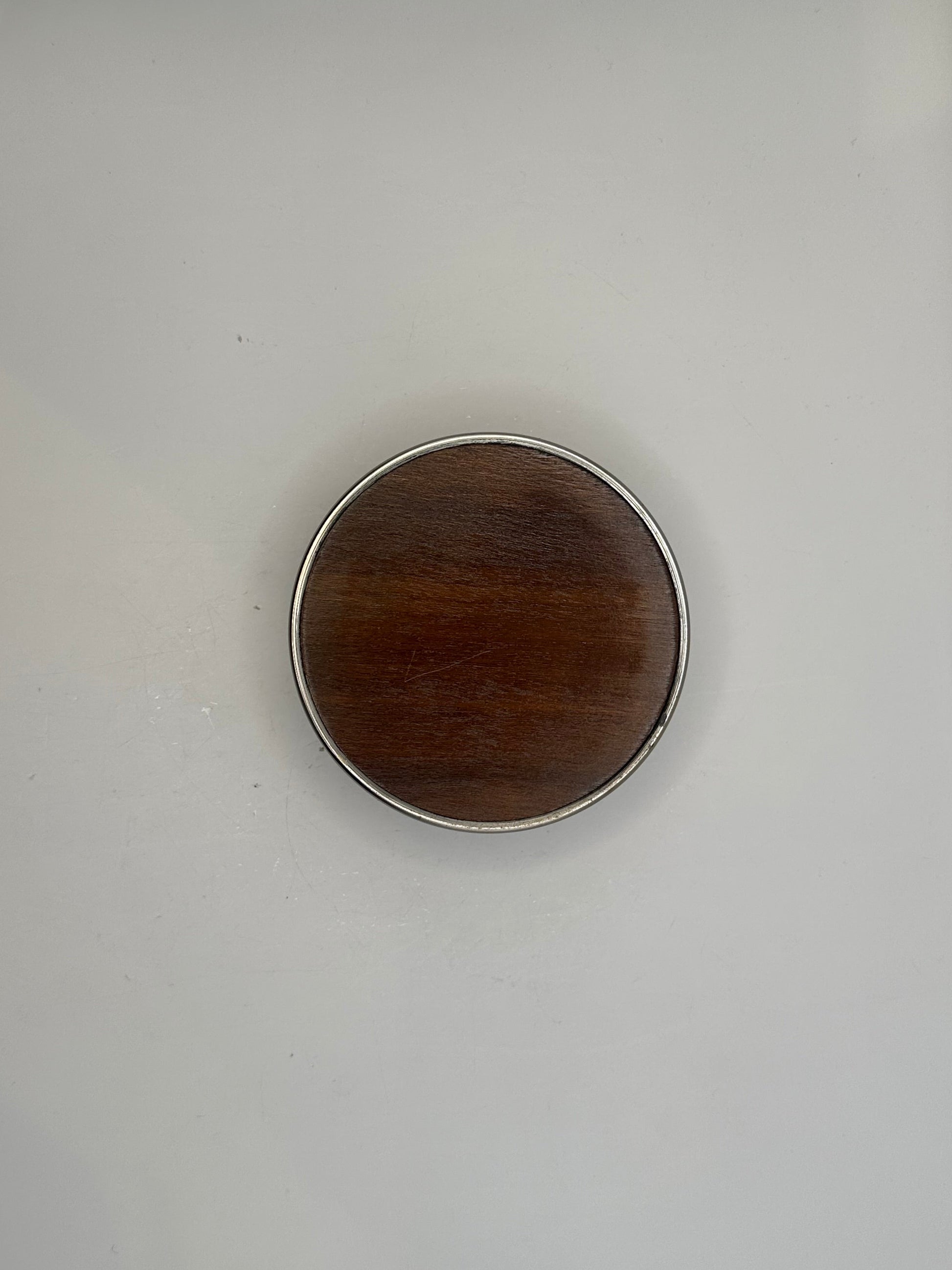 Top-down view of the bottle coaster showing its turned wood base