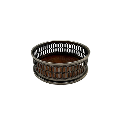 Silver-plate wine bottle coaster with a pierced lattice gallery and turned wood base, angled view
