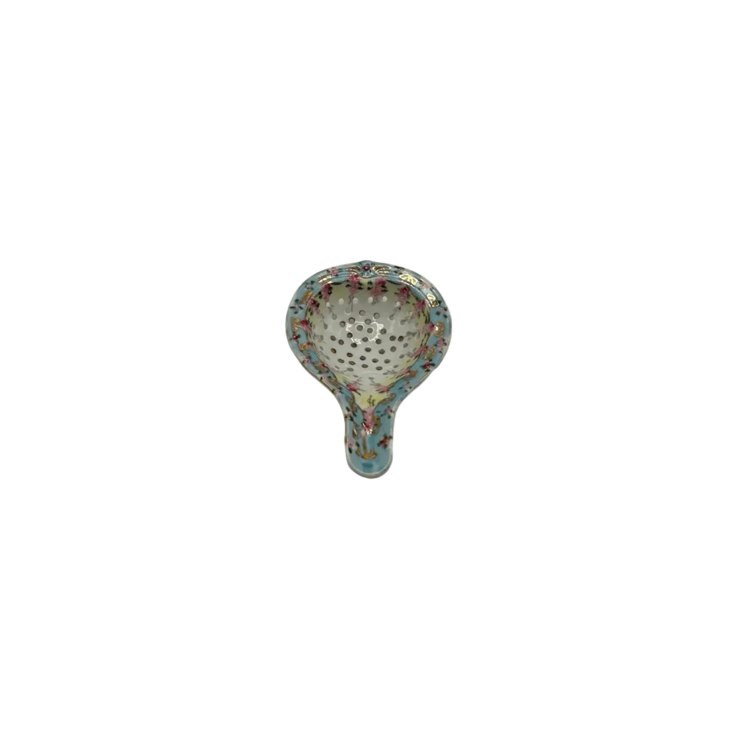 Porcelain tea strainer with a perforated bowl and handle, hand-painted with pink florals and a blue-and-gold rim