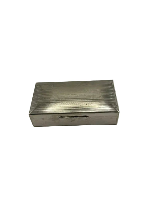 Rectangular silver-plate cigarette box with a linear engine-turned lid, top view