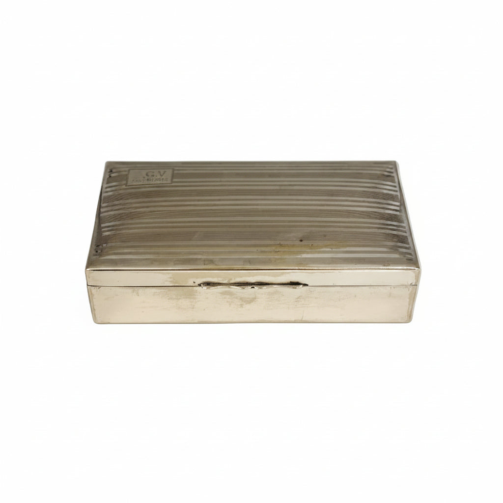 Front-angled view of the cigarette box showing its lined lid and engraved cartouche