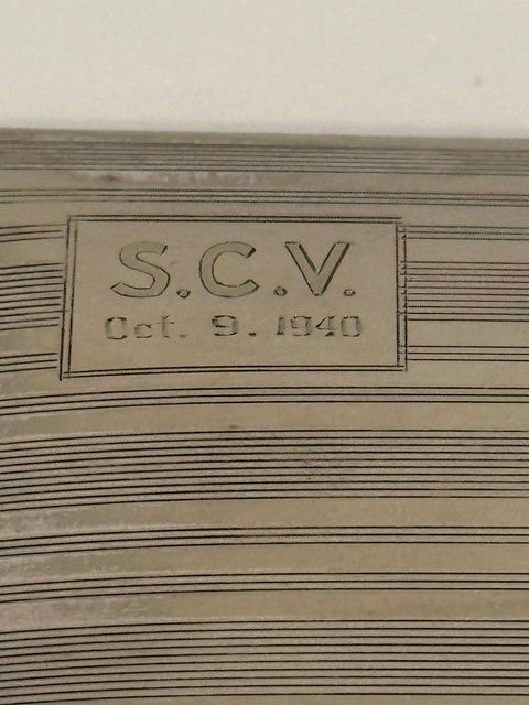 Close-up of the engraved cartouche reading 'S.C.V. Oct. 9, 1940' on the lined lid