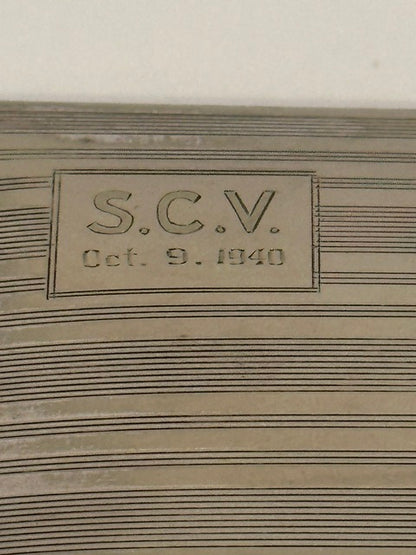 Close-up of the engraved cartouche reading 'S.C.V. Oct. 9, 1940' on the lined lid