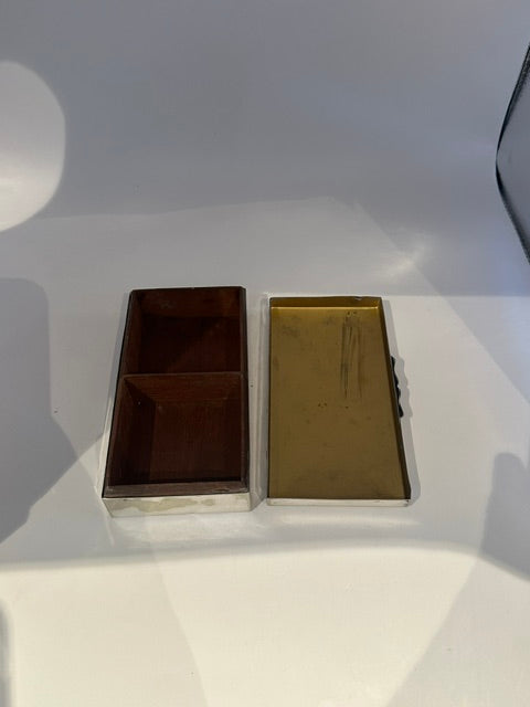 Open cigarette box showing the divided wood interior and gilt-lined lid