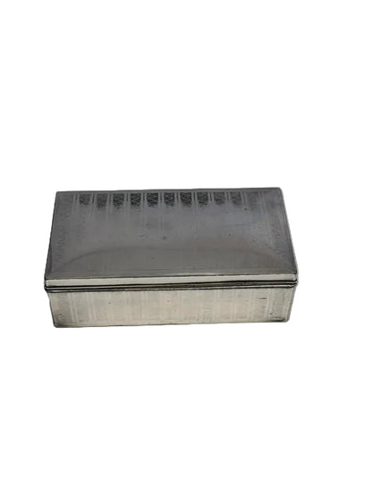 Rectangular silver-plate cigarette box with an engine-turned lid, top view