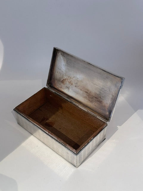Open cigarette box showing the silver hinged lid and wood-lined interior